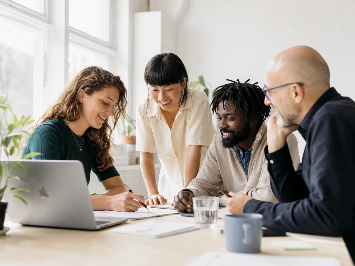 A small agency team reviewing project work together