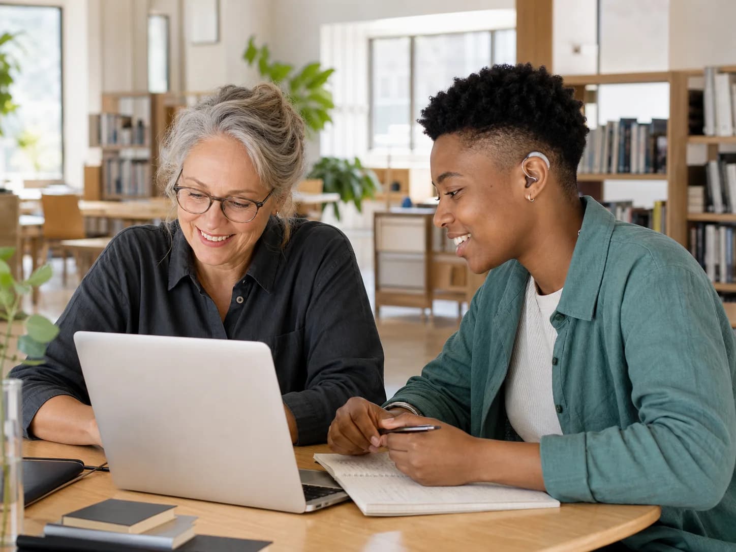 Two colleagues reviewing a support question together in a bright workspace